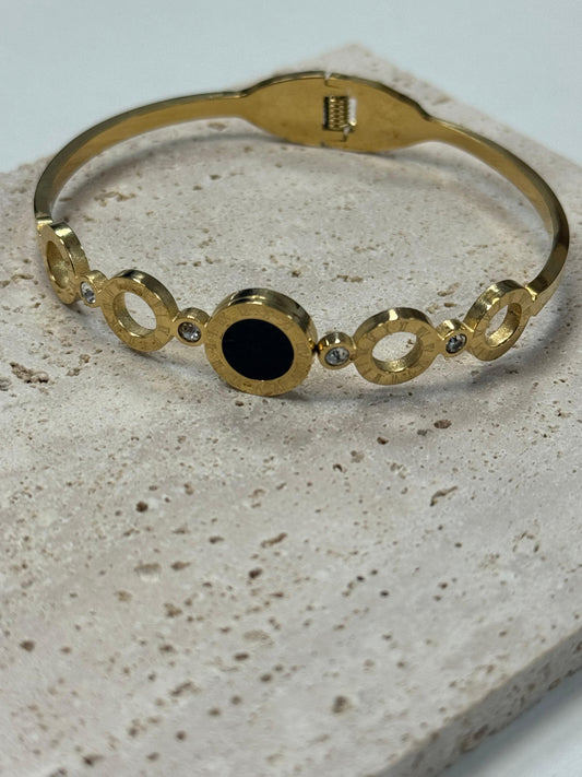 Eleganter Armreif aus Edelstahl mit schwarzen und funkelnden Akzenten – Goldfarben